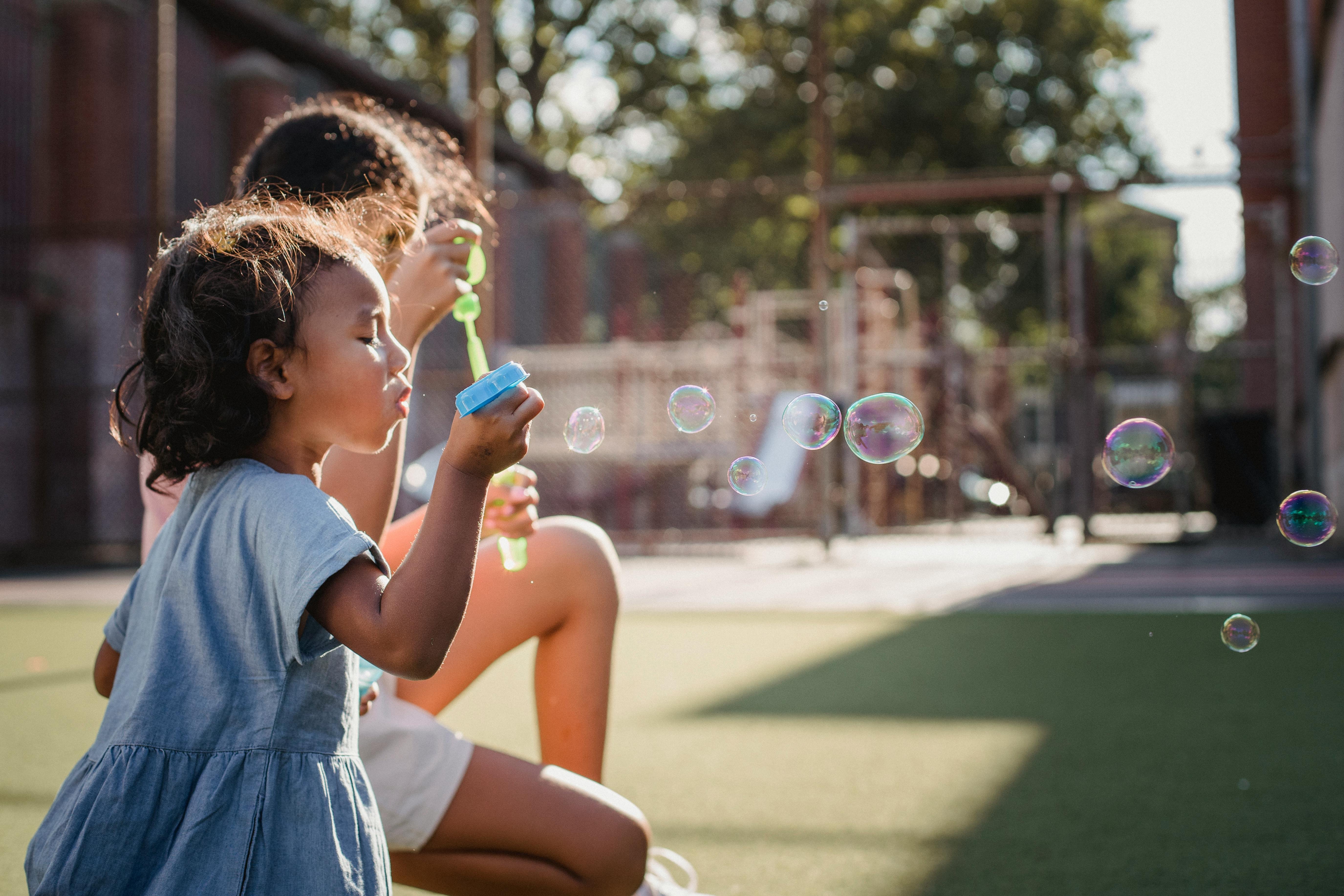 children blowing bubbles